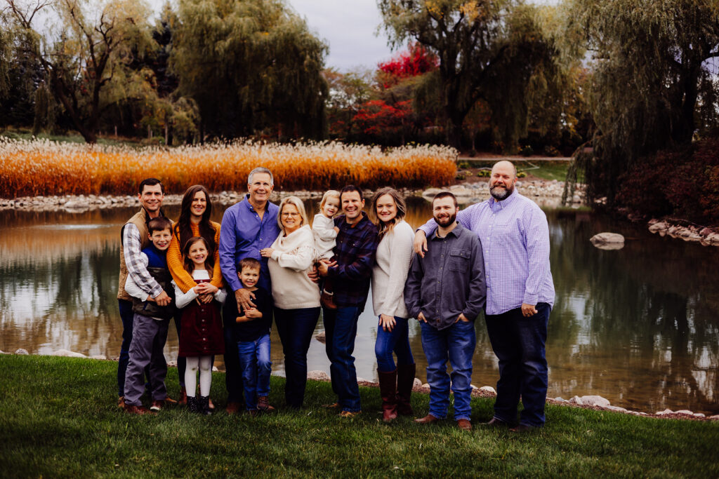 Extended Roe family group photo by a pond in Sheboygan, WI during a colorful fall family photo session.
